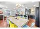 Open-concept kitchen features a large island, stainless steel appliances, and dark wood cabinets at 424 Hopwood Way Way, Apex, NC 27523