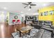Spacious living room with hardwood floors, dark leather furniture, and neutral tones at 424 Hopwood Way Way, Apex, NC 27523