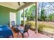 Relaxing covered patio with chairs, a small table, and a view of the backyard at 424 Hopwood Way Way, Apex, NC 27523