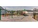 Well-maintained playground featuring multiple play structures and swings surrounded by a safety fence at 424 Hopwood Way Way, Apex, NC 27523