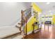 Elegant staircase with carpeted steps, wood railing, and decorative iron spindles at 424 Hopwood Way Way, Apex, NC 27523