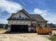 New construction home featuring a two-car garage and modern architectural details at 450 Springtooth Dr, Zebulon, NC 27597