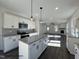 Open kitchen with granite island flows into the spacious living area at 450 Springtooth Dr, Zebulon, NC 27597
