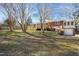 Landscaped backyard offering privacy, mature trees, and house with a deck at 4605 Erwin Rd, Durham, NC 27705