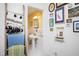 Bright bathroom featuring a pedestal sink, white tile flooring and sunny yellow walls at 4605 Erwin Rd, Durham, NC 27705