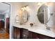 Bathroom featuring double sinks, vanity with dark wood cabinets, and modern fixtures at 4605 Erwin Rd, Durham, NC 27705