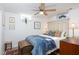 Cozy bedroom with a soft blue quilt, antique chest, ceiling fan and natural lighting at 4605 Erwin Rd, Durham, NC 27705