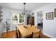 Bright dining area with a large wood table and a view of the outdoors at 4605 Erwin Rd, Durham, NC 27705