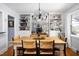 Elegant dining room featuring built-in shelves and a decorative chandelier at 4605 Erwin Rd, Durham, NC 27705