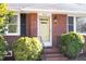 Close-up of the brick front with yellow door and decorative lamp, showcasing the home's entrance at 4605 Erwin Rd, Durham, NC 27705