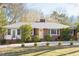 Traditional brick home with well-kept lawn, featuring a bright front door and inviting entrance at 4605 Erwin Rd, Durham, NC 27705