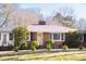 Attractive brick home with a classic design, well-maintained lawn, and mature trees around the property at 4605 Erwin Rd, Durham, NC 27705