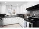 Efficient kitchen with stainless steel counters, white cabinets, and modern appliances at 4605 Erwin Rd, Durham, NC 27705