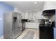 Spacious kitchen featuring stainless steel appliances and white cabinetry at 4605 Erwin Rd, Durham, NC 27705