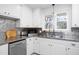 Well-lit kitchen with stainless steel countertops and updated appliances at 4605 Erwin Rd, Durham, NC 27705