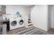 Bright laundry room with modern appliances and shelving for organized convenience at 4605 Erwin Rd, Durham, NC 27705