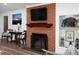 Charming living room showcasing a brick fireplace, built-in shelving, and a comfortable seating area at 4605 Erwin Rd, Durham, NC 27705