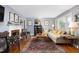 Comfortable living room with fireplace, large sofa, and a colorful rug creating a warm atmosphere at 4605 Erwin Rd, Durham, NC 27705