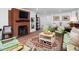 Cozy living room featuring a brick fireplace, comfortable seating, and a well-lit atmosphere at 4605 Erwin Rd, Durham, NC 27705