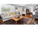 Bright and airy living room with hardwood floors, a large window, and a view into the dining area at 4605 Erwin Rd, Durham, NC 27705