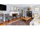 Cozy living room featuring a fireplace, hardwood floors, patterned chairs, and a decorative area rug at 4605 Erwin Rd, Durham, NC 27705