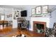 Stylish living room featuring a fireplace, TV, and a view into the adjacent dining area at 4605 Erwin Rd, Durham, NC 27705