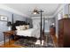 Bright main bedroom featuring a ceiling fan, hardwood floors, and balcony access at 4605 Erwin Rd, Durham, NC 27705