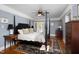 Bright main bedroom featuring a ceiling fan, hardwood floors, and balcony access at 4605 Erwin Rd, Durham, NC 27705