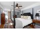 Spacious main bedroom with hard wood flooring, ceiling fan, and a four-post bed at 4605 Erwin Rd, Durham, NC 27705