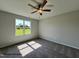 Serene bedroom bathed in natural light, showcasing a ceiling fan and a peaceful atmosphere at 472 Springtooth Dr, Zebulon, NC 27597