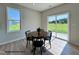 Cozy dining area features a round wood table with seating, complemented by natural light and outdoor views at 472 Springtooth Dr, Zebulon, NC 27597