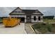 Front exterior of a new home under construction, with a garage, and lawn surrounded by trees at 472 Springtooth Dr, Zebulon, NC 27597