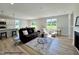Open-concept living space with modern furnishings, fireplace, and expansive windows for natural light at 472 Springtooth Dr, Zebulon, NC 27597