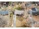 Aerial view of a home with a large yard, mature trees, and a long driveway at 4816 Stafford Dr, Durham, NC 27705