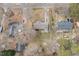 A bird's eye view showing the house nestled among mature trees in a quiet neighborhood at 4816 Stafford Dr, Durham, NC 27705