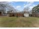 The home's exterior back view highlights a brick facade, cozy patio, and well-maintained yard space at 4816 Stafford Dr, Durham, NC 27705