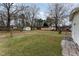 Expansive backyard features a lush lawn, storage shed, and detached garage perfect for outdoor activities at 4816 Stafford Dr, Durham, NC 27705