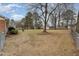 Expansive backyard with a large tree, green space, and a partial view of the fence line at 4816 Stafford Dr, Durham, NC 27705