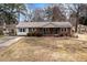 Charming brick ranch-style home with blue shutters and a well-maintained front yard at 4816 Stafford Dr, Durham, NC 27705