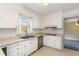 Well-lit kitchen with white cabinets and stainless steel appliances at 4816 Stafford Dr, Durham, NC 27705