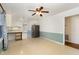 Bright kitchen and dining area featuring updated stainless steel refrigerator and a stylish ceiling fan at 4816 Stafford Dr, Durham, NC 27705