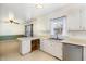Bright kitchen featuring white cabinetry, stainless steel appliances, and a breakfast bar at 4816 Stafford Dr, Durham, NC 27705