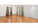 Bright living room featuring hardwood floors and ample natural light from two windows at 4816 Stafford Dr, Durham, NC 27705