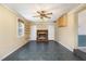 Cozy living room featuring a brick fireplace, built-in shelving, and natural light from a large window at 4816 Stafford Dr, Durham, NC 27705