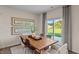 Bright dining area with a wooden table, modern chairs, natural light, and backyard view at 50 Granite Falls Way, Youngsville, NC 27596