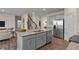 Well-equipped kitchen island featuring granite countertop, stainless steel appliances and eat-in bar at 50 Granite Falls Way, Youngsville, NC 27596