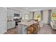 Modern kitchen with granite countertops, gray cabinets, stainless steel appliances, and a large island with seating at 50 Granite Falls Way, Youngsville, NC 27596