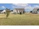 Expansive backyard showcasing a swing set and playhouse, ideal for a Gathering at 55 Oak Leaf Dr, Lillington, NC 27546