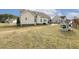 Spacious backyard with a playhouse and swing set, perfect for outdoor fun at 55 Oak Leaf Dr, Lillington, NC 27546