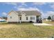 View of the home's back exterior featuring a screened porch, patio, and well-maintained lawn at 55 Oak Leaf Dr, Lillington, NC 27546